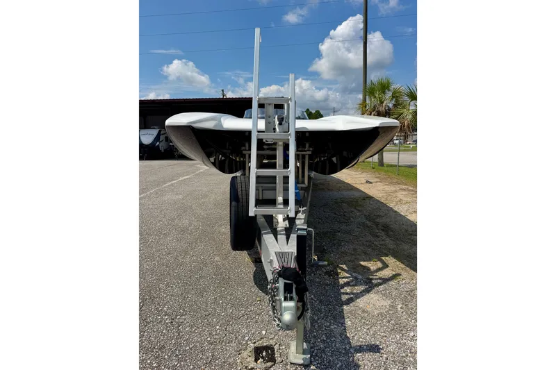 Slide: The Image of 2024 Fountain 34 Thundercat boat on trailer, parked outdoors under blue sky. - 18