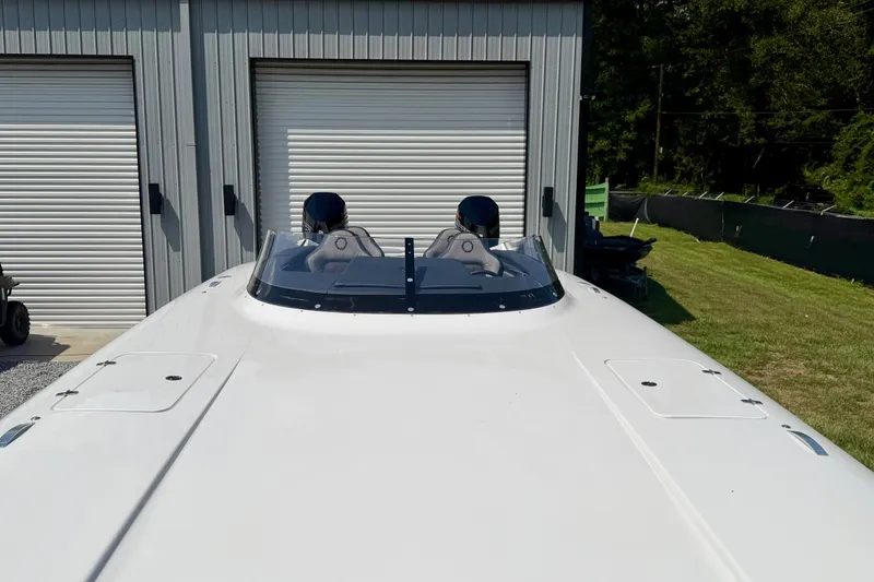 Slide: The Image of 2024 Fountain 34 Thundercat boat parked outside a garage with closed doors. - 28