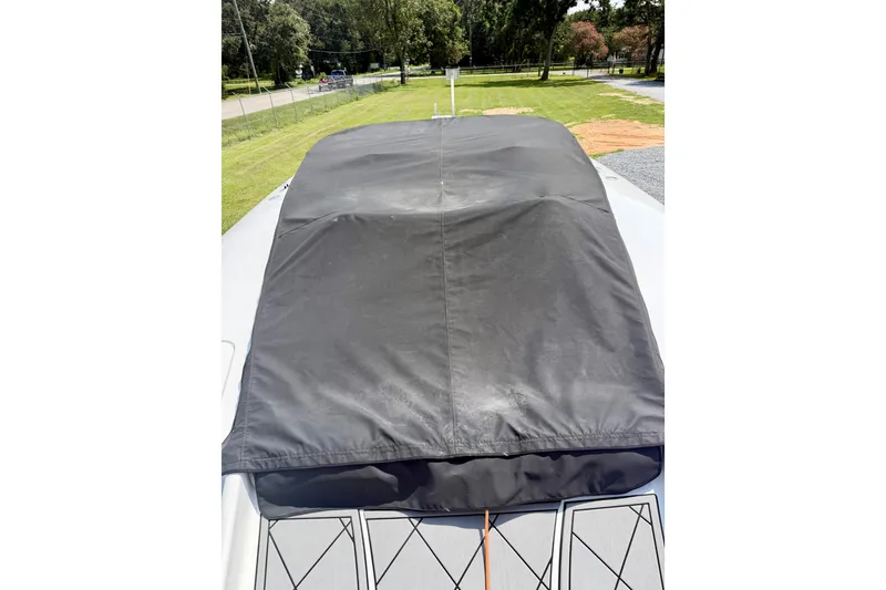 Slide: The Image of 2024 Fountain 34 Thundercat boat with protective cover, parked outdoors. - 47