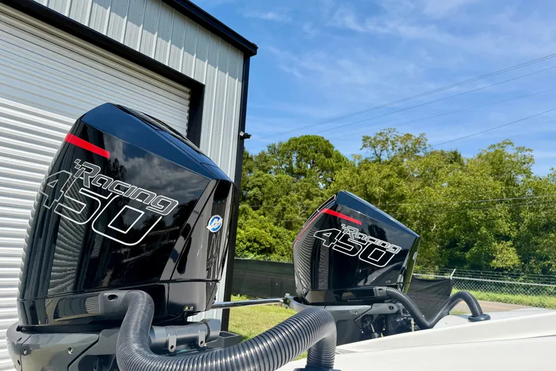 Slide: The Image of Twin Racing 450 engines on a 2024 Fountain 34 Thundercat boat, outdoors. - 33