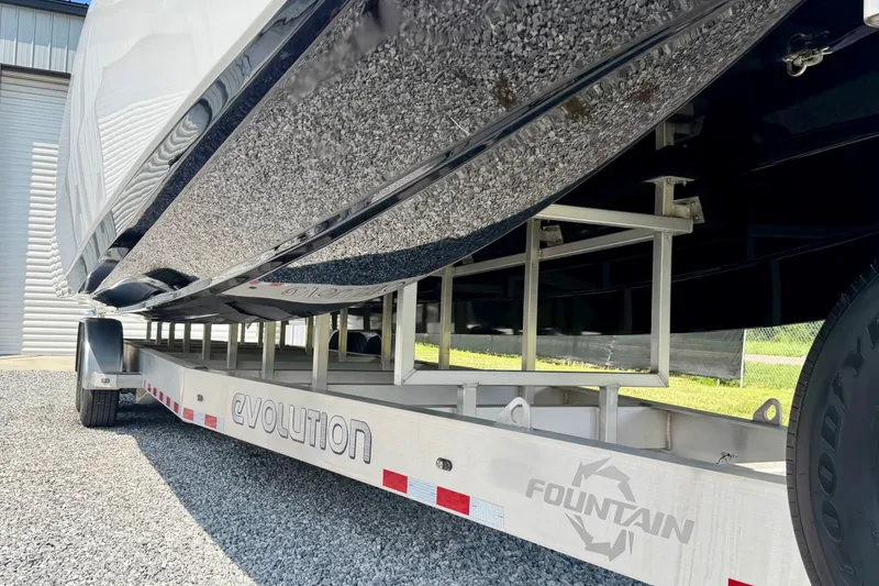 Slide: The Image of 2024 Fountain 34 Thundercat boat on Evolution trailer, parked on gravel. - 26