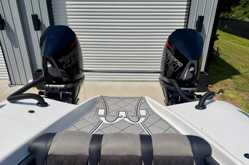 Slide: The Image of 2024 Fountain 34 Thundercat boat with dual powerful outboard engines in a garage setting. - 39