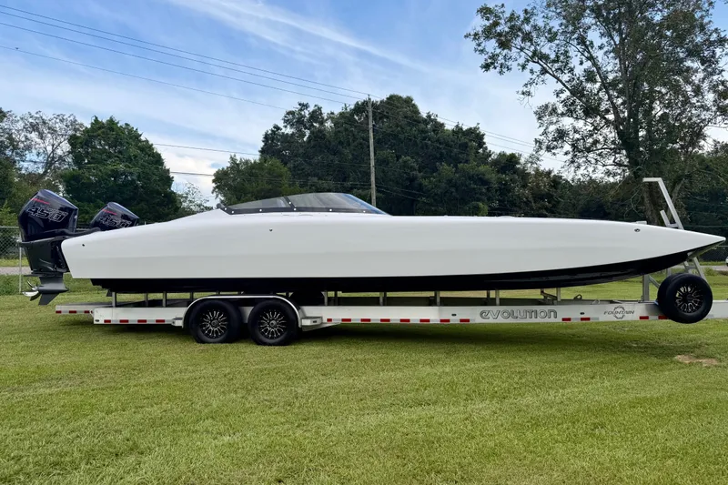 The Image of 2024 Fountain 34 Thundercat boat on trailer, featuring twin outboard engines, parked on grass. - 20