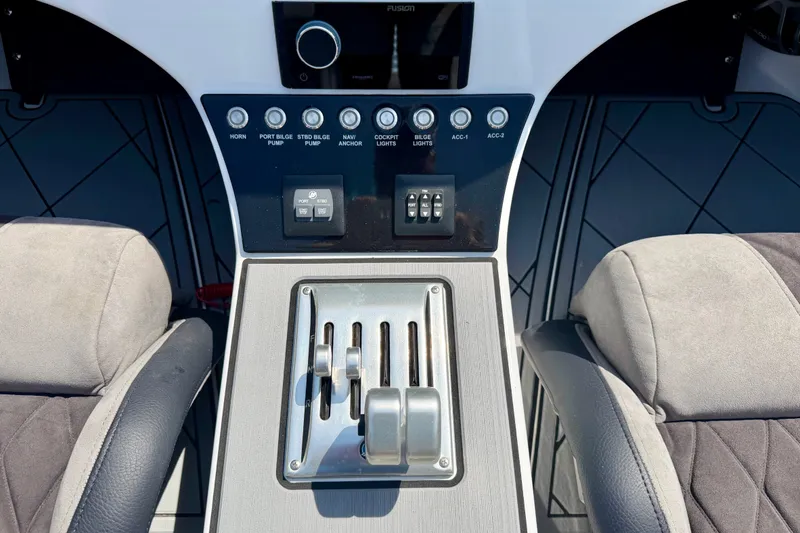 Slide: The Image of Control panel of 2024 Fountain 34 Thundercat boat with switches and throttle levers. - 43