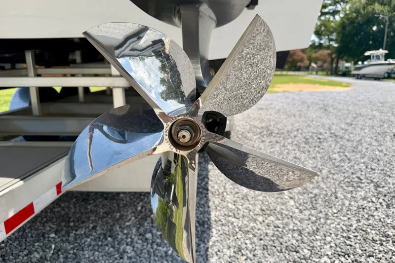 Slide: The Image of Close-up of a 2024 Fountain 34 Thundercat boat propeller on gravel surface. - 35