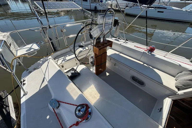 Slide: The Image of Cockpit of 2006 Catalina 320 sailboat with steering wheel and seating, docked at marina. - 10