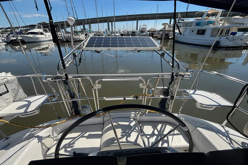 Slide: The Image of Cockpit view of 2006 Catalina 320 sailboat with solar panel, docked in marina. - 11