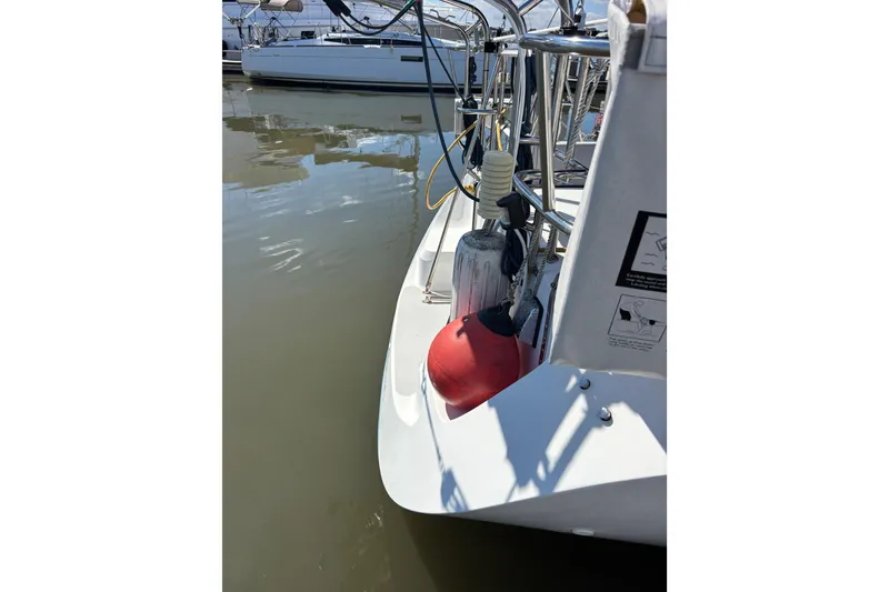 Slide: The Image of Catalina 320 sailboat, 2006 model, docked with visible fenders and equipment. - 13