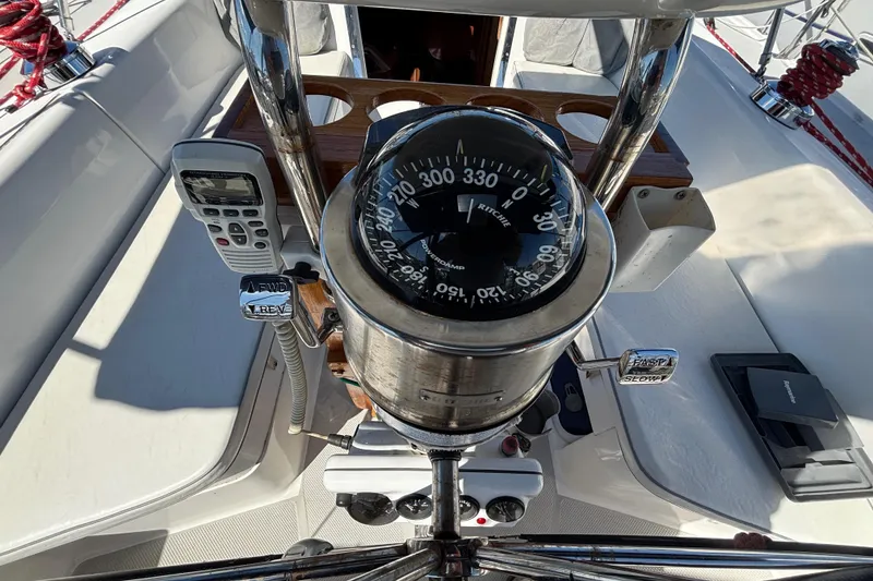 Slide: The Image of Cockpit of 2006 Catalina 320 sailboat with compass and navigation controls. - 16