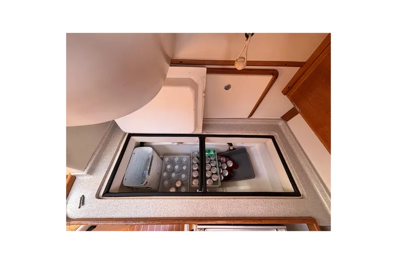Slide: The Image of Interior view of 2006 Catalina 320 yacht galley with open fridge and beverages. - 30