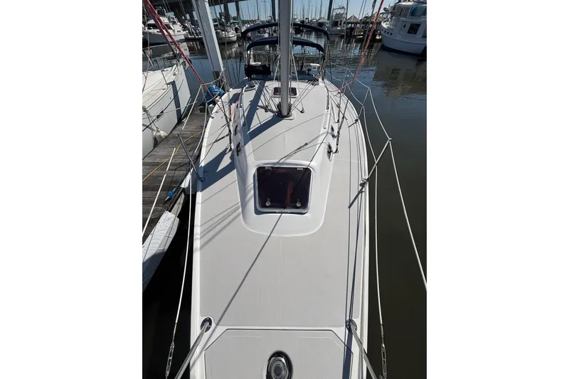 Slide: The Image of 2006 Catalina 320 sailboat docked at marina, view of deck and rigging. - 7