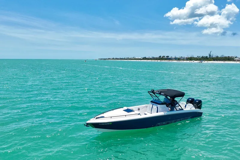Slide: The Image of 2018 Renegade 32' Cuddy boat on turquoise water under a clear blue sky. - 14