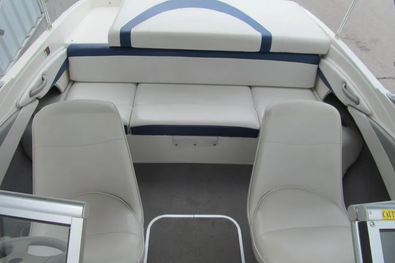 Slide: The Image of 2005 Bayliner 185 boat interior with white and blue seating arrangement. - 11