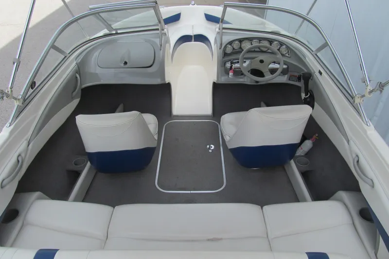 Slide: The Image of Interior of a 2005 Bayliner 185 boat, featuring seating and steering wheel. - 5