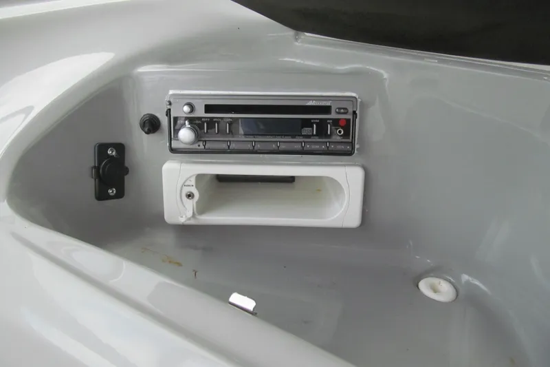 Slide: The Image of 2005 Bayliner 185 boat dashboard with stereo system and storage compartment. - 7