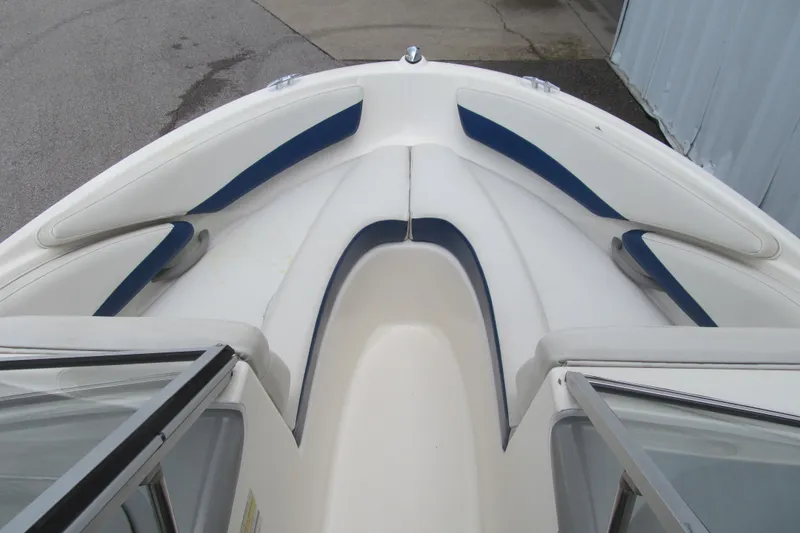 Slide: The Image of 2005 Bayliner 185 boat interior with white and blue seating. - 8