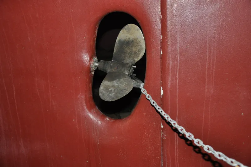 Slide: The Image of Propeller of 1970 Hinckley Bermuda 40 sailboat with red hull and chain detail. - 10