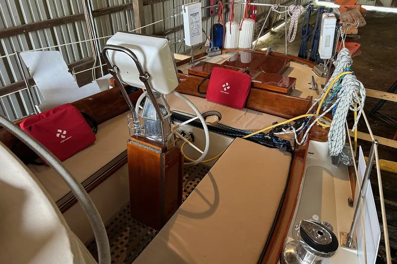 Slide: The Image of Interior view of a 1970 Hinckley Bermuda 40 sailboat with steering wheel and ropes. - 11