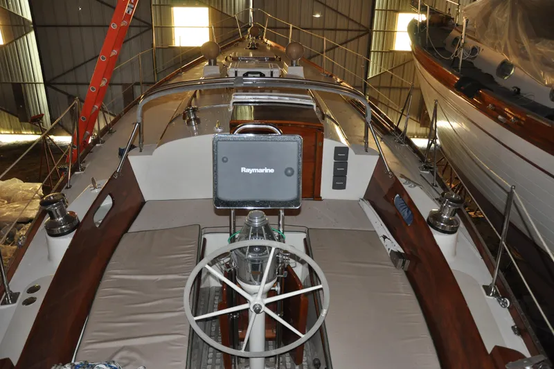 Slide: The Image of 1970 Hinckley Bermuda 40 sailboat interior with steering wheel and navigation equipment. - 12