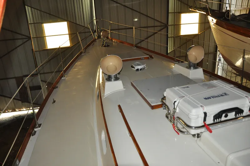 Slide: The Image of 1970 Hinckley Bermuda 40 yacht deck in storage, showcasing sleek design and equipment. - 15