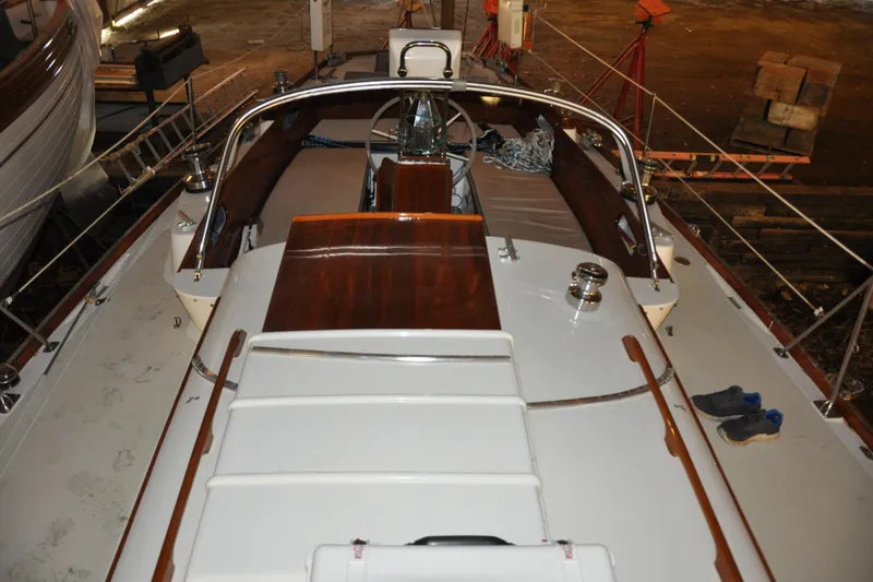Slide: The Image of 1970 Hinckley Bermuda 40 sailboat deck with wooden accents and nautical equipment. - 17