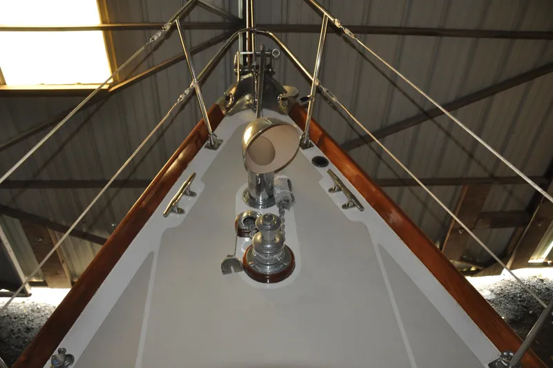 Slide: The Image of Bow of a 1970 Hinckley Bermuda 40 sailboat in a storage facility. - 18