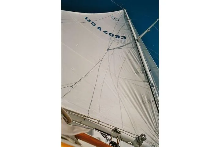 Slide: The Image of Sailing yacht Hinckley Bermuda 40, 1970 model, with sails unfurled against a clear sky. - 2