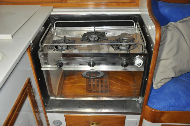 Slide: The Image of 1970 Hinckley Bermuda 40 yacht kitchen with stainless steel stove and oven. - 22