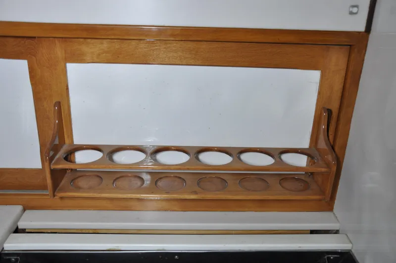 Slide: The Image of Wooden cup holder on a 1970 Hinckley Bermuda 40 sailboat interior. - 23