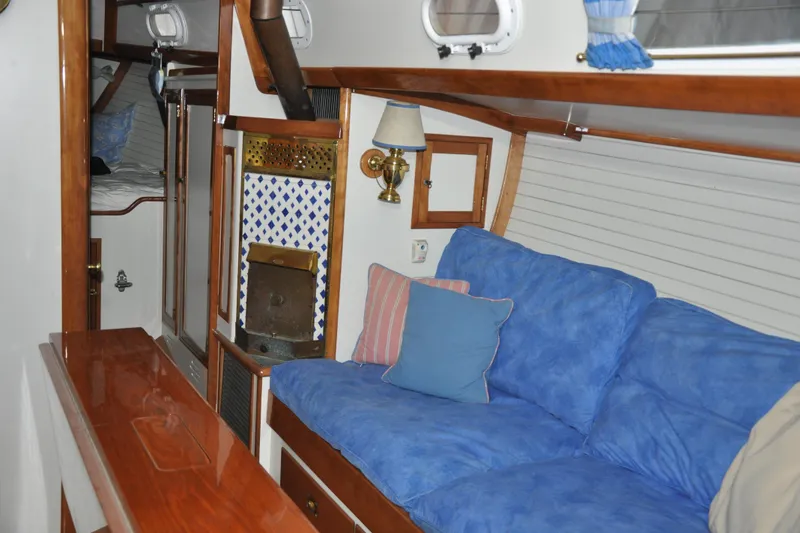Slide: The Image of Interior of a 1970 Hinckley Bermuda 40 sailboat with blue cushions and wooden accents. - 26