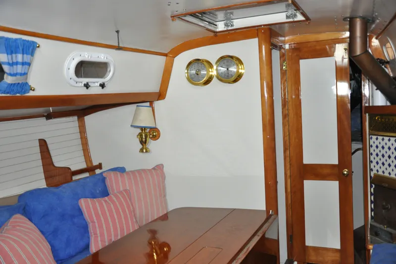 Slide: The Image of Interior of a 1970 Hinckley Bermuda 40 sailboat with wood accents and nautical decor. - 27