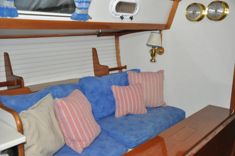Slide: The Image of Interior of 1970 Hinckley Bermuda 40 with blue and striped cushions. - 28