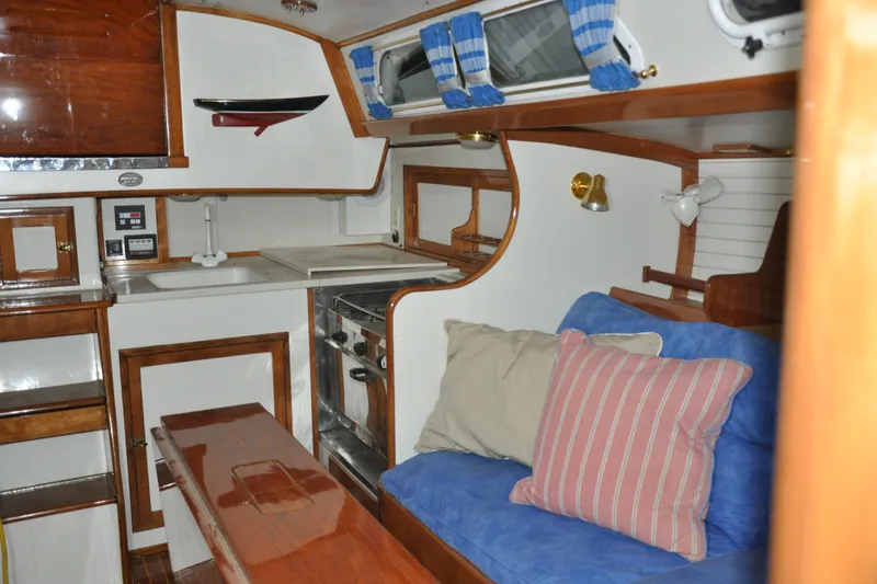 Slide: The Image of Interior of a 1970 Hinckley Bermuda 40 sailboat with cozy seating and compact kitchen. - 29