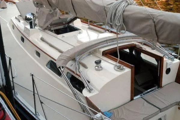 Slide: The Image of 1970 Hinckley Bermuda 40 sailboat with beige deck and covered mast. - 3