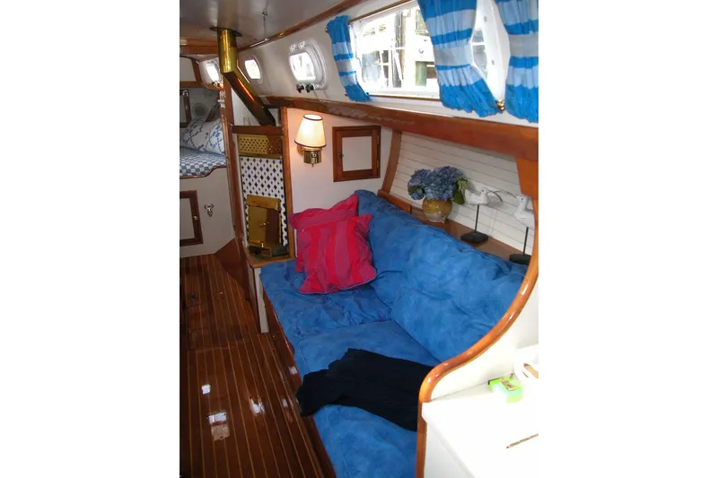 Slide: The Image of Interior of a 1970 Hinckley Bermuda 40 sailboat with blue seating and nautical decor. - 30