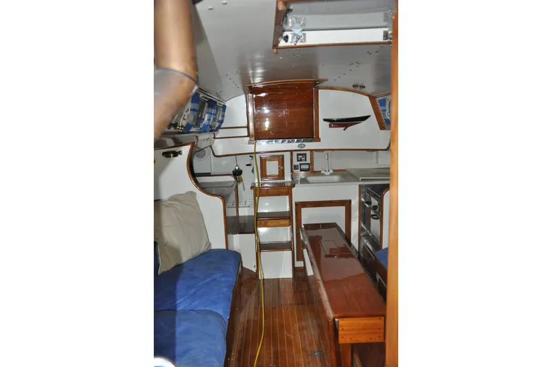 Slide: The Image of Interior of a 1970 Hinckley Bermuda 40 sailboat, featuring wooden furnishings and compact design. - 31