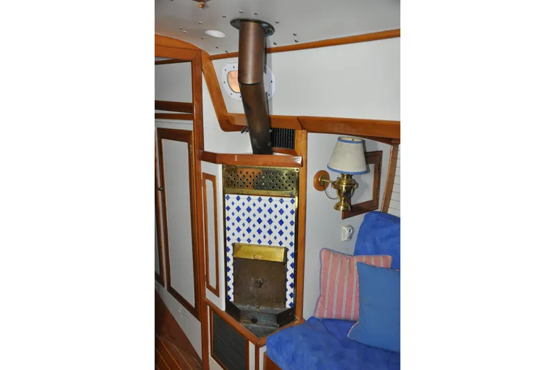 Slide: The Image of Interior of 1970 Hinckley Bermuda 40 sailboat with stove and cozy seating area. - 32