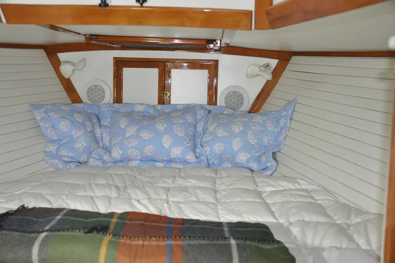 Slide: The Image of Cozy cabin interior of a 1970 Hinckley Bermuda 40 sailboat with blue pillows. - 34