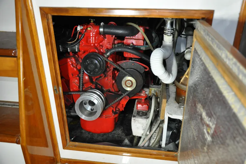 Slide: The Image of Engine compartment of a 1970 Hinckley Bermuda 40 sailboat, showcasing a red engine. - 42