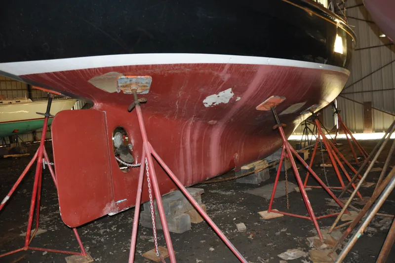 Slide: The Image of 1970 Hinckley Bermuda 40 sailboat hull on stands in a boatyard. - 6