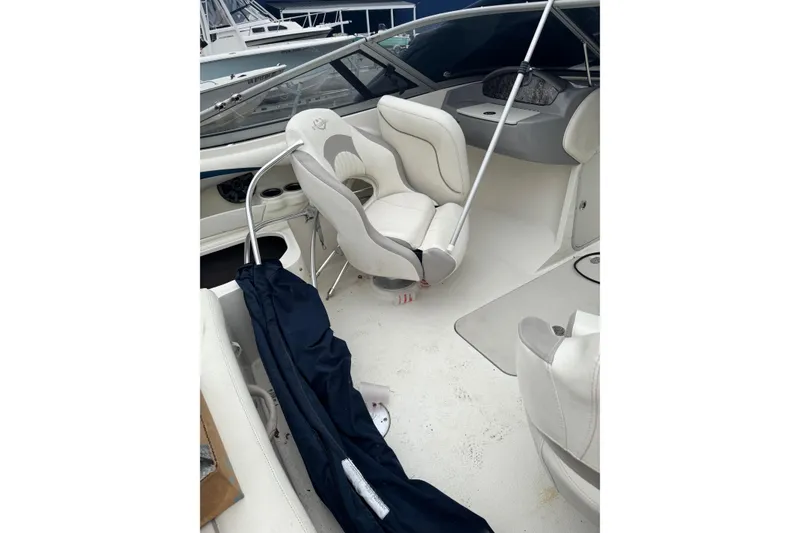 Slide: The Image of 2013 Stingray 204 LR boat interior with white seating and steering console. - 7