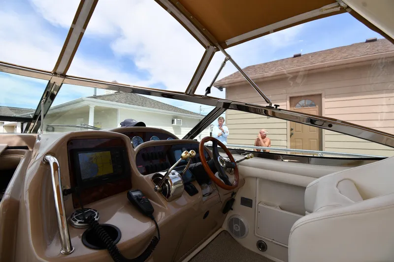 Slide: The Image of Interior view of 2003 Sea Ray 360 Sundancer boat cockpit with steering wheel and navigation equipment. - 10