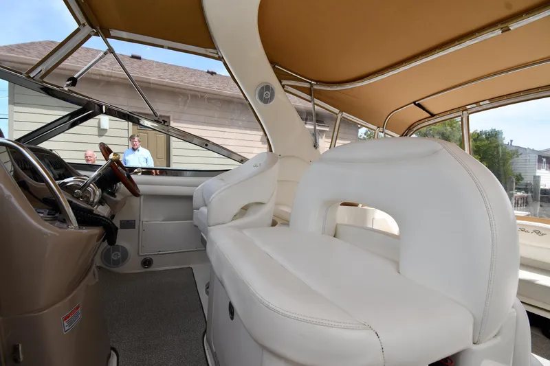 Slide: The Image of Interior view of 2003 Sea Ray 360 Sundancer with white seating and tan canopy. - 13