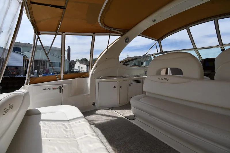 Slide: The Image of Interior view of 2003 Sea Ray 360 Sundancer yacht with beige seating and canopy. - 15