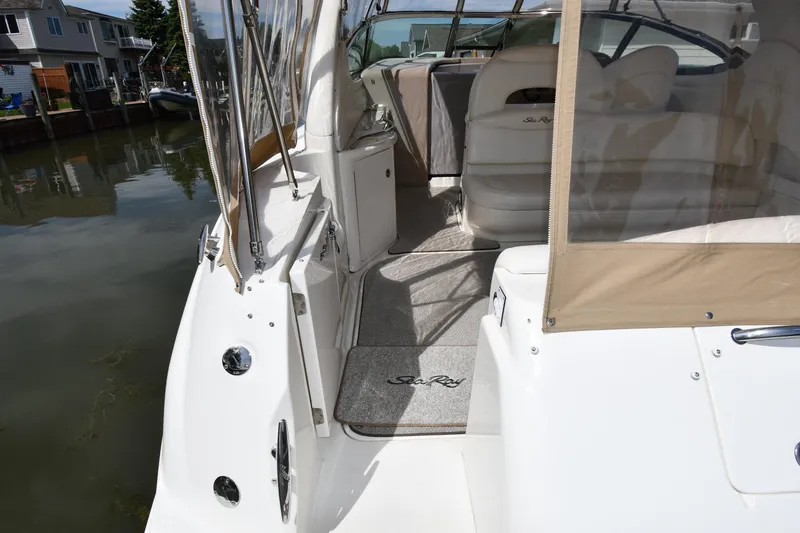 Slide: The Image of 2003 Sea Ray 360 Sundancer yacht interior with beige upholstery and clear canopy. - 20