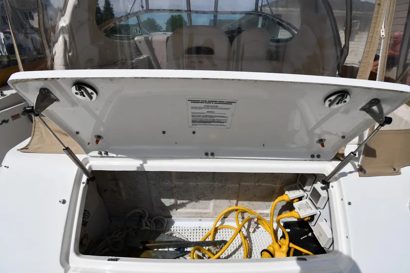 Slide: The Image of Open storage compartment on a 2003 Sea Ray 360 Sundancer boat with cables and equipment. - 21