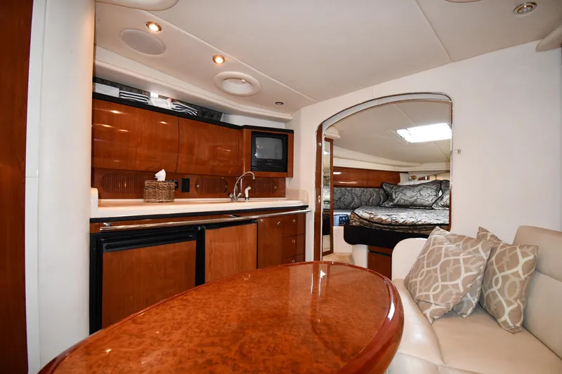 Slide: The Image of Luxurious interior of 2003 Sea Ray 360 Sundancer yacht with kitchen and cozy seating area. - 30