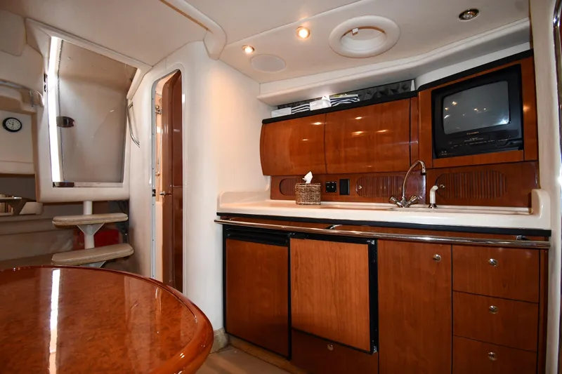 Slide: The Image of Interior of 2003 Sea Ray 360 Sundancer yacht with kitchenette and wooden cabinetry. - 31