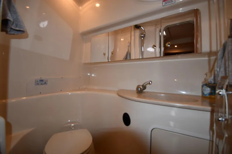 Slide: The Image of Bathroom interior of 2003 Sea Ray 360 Sundancer yacht, featuring sink and storage cabinets. - 34