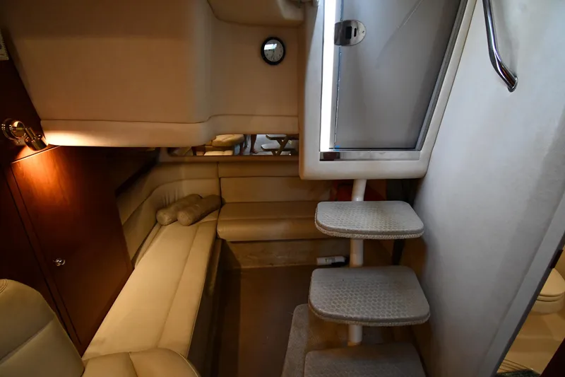 Slide: The Image of Interior of 2003 Sea Ray 360 Sundancer yacht, featuring cozy seating and carpeted steps. - 35